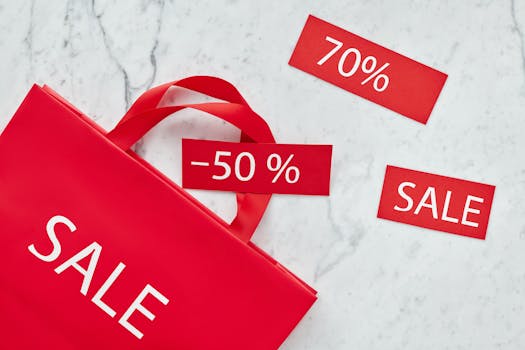 Home Red shopping bag and discount cards with percentages for promotional sale.